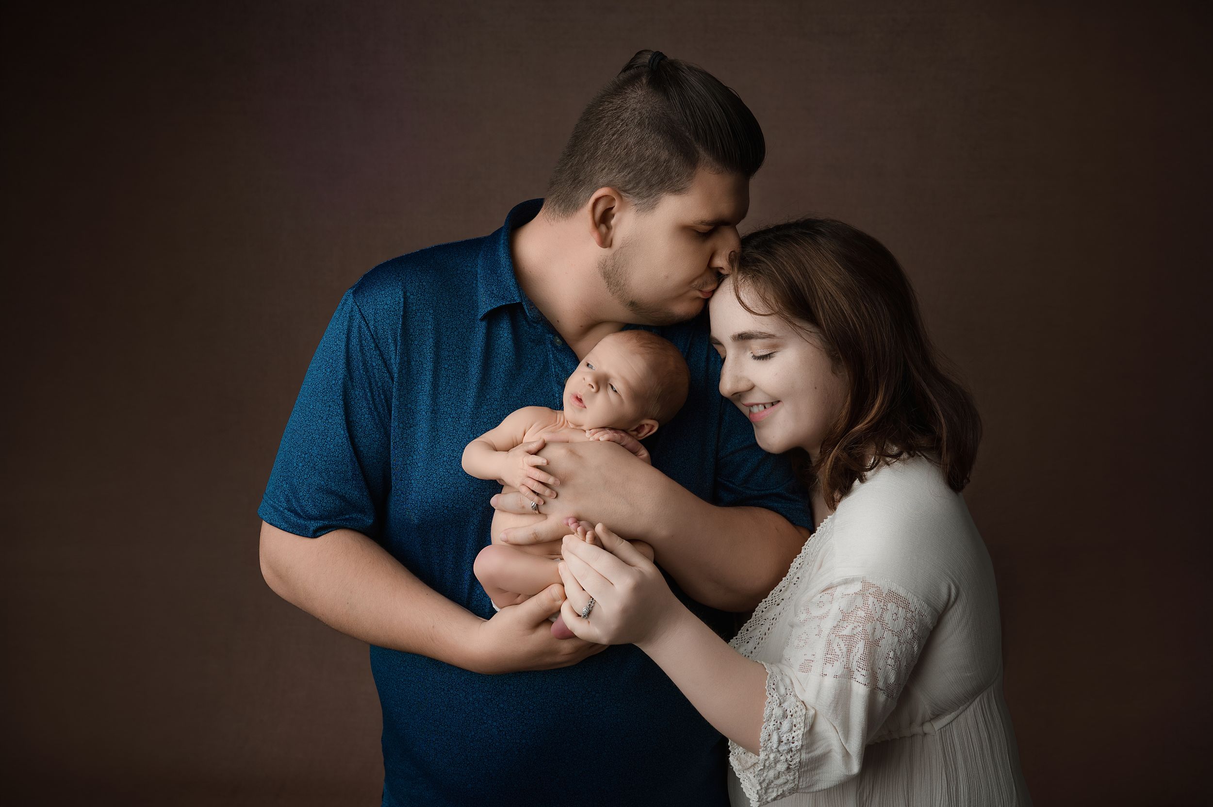 Three similar photos of a family with a baby captured in warm, intimate lighting with dark background tones.