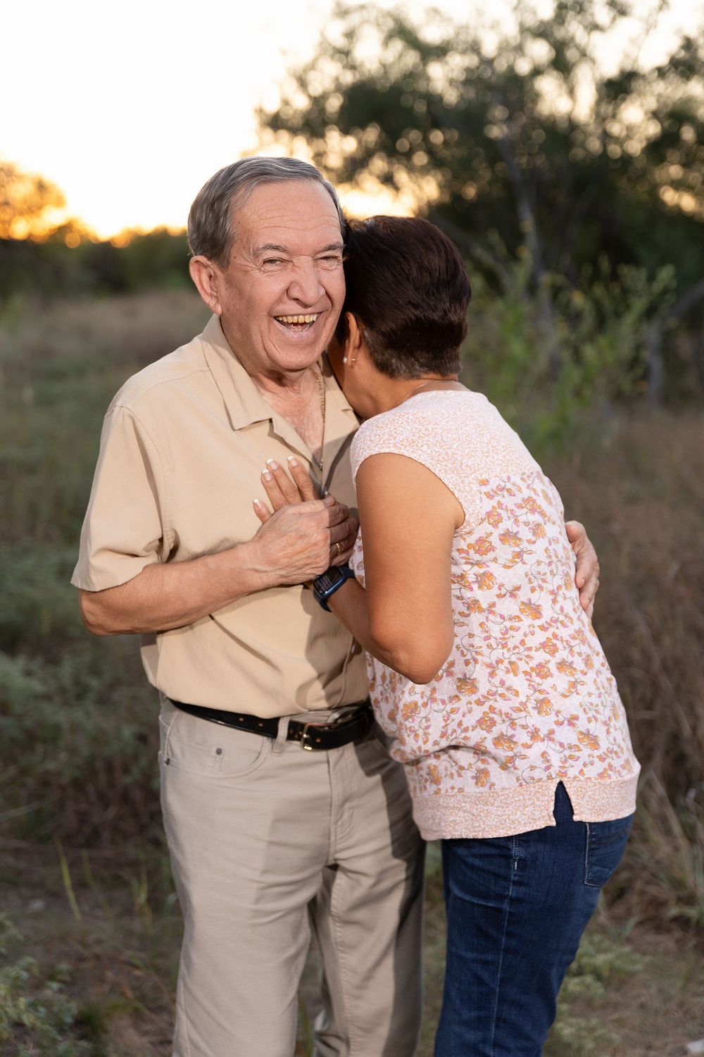 A couple shares joyful moments together outdoors during sunset, embracing and laughing in a series of candid photos.