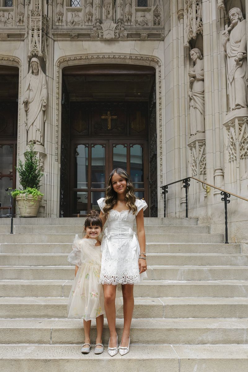 Baptism girl with little sister at St. Thomas Church in NYC, captured by Paula Brearley