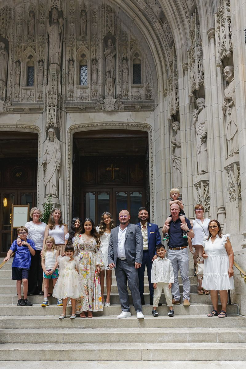 Family group at St. Thomas Church entrance stairs by NYC family photographer Paula Brearley