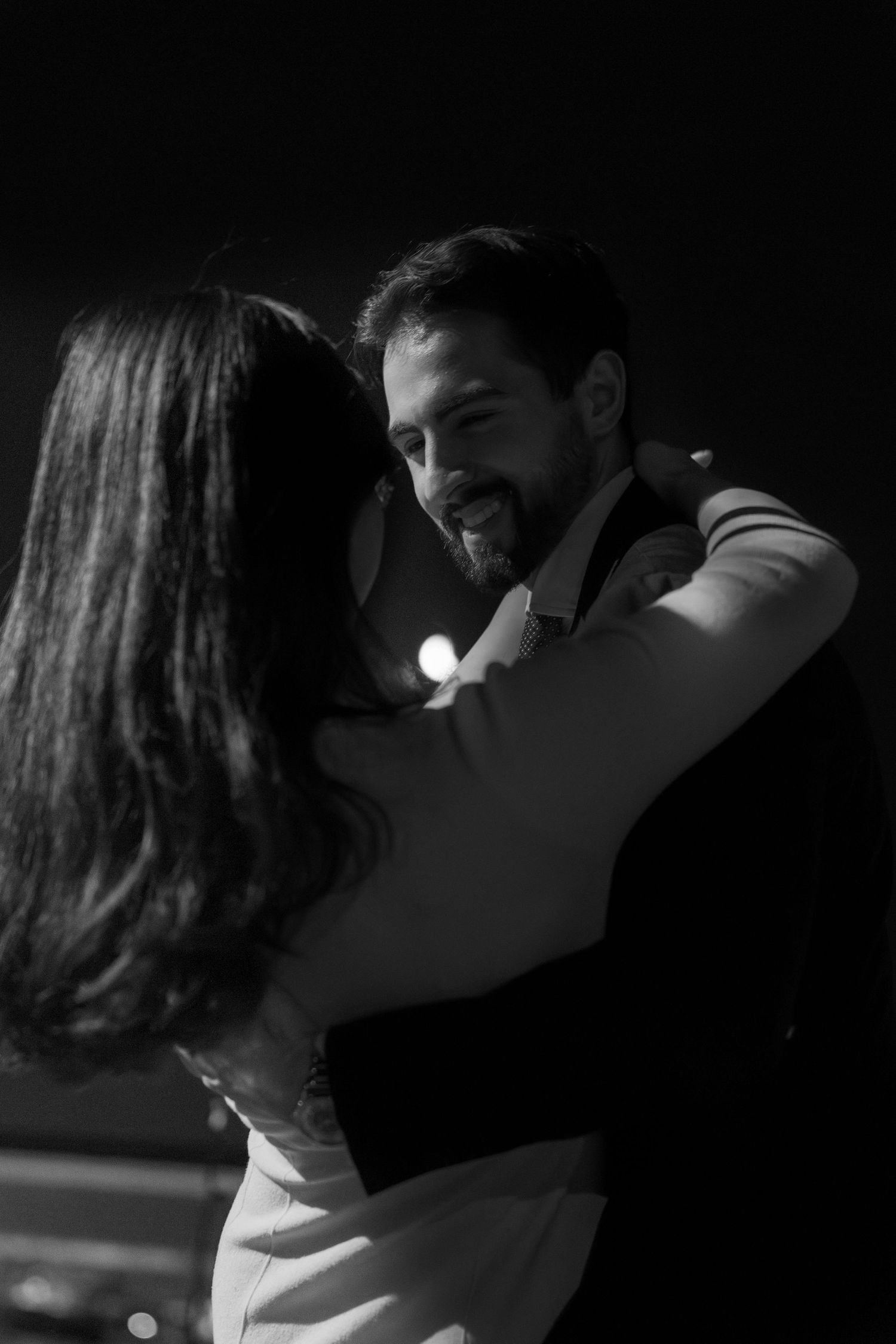 A romantic black and white sequence showing a couple kissing in dramatic lighting and shadows.