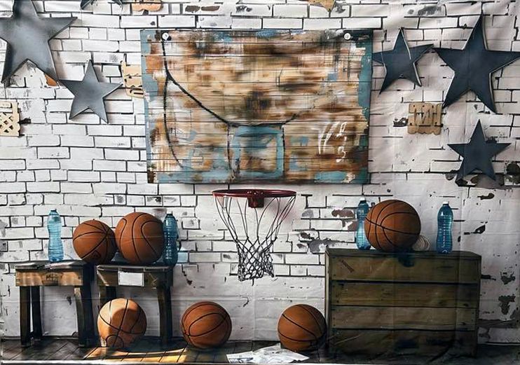 Basketball memorabilia display with vintage basketballs, hoops, and star decorations against a white brick wall.
