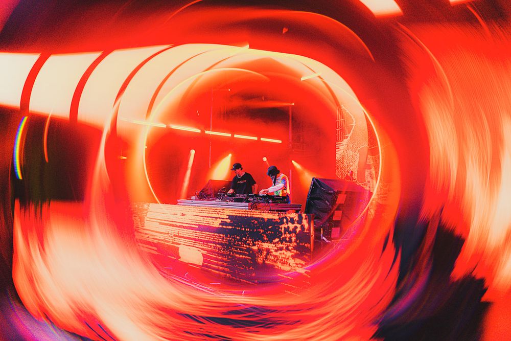 Spiral tunnel effect with intense red lighting and architectural elements creating a vortex-like appearance.