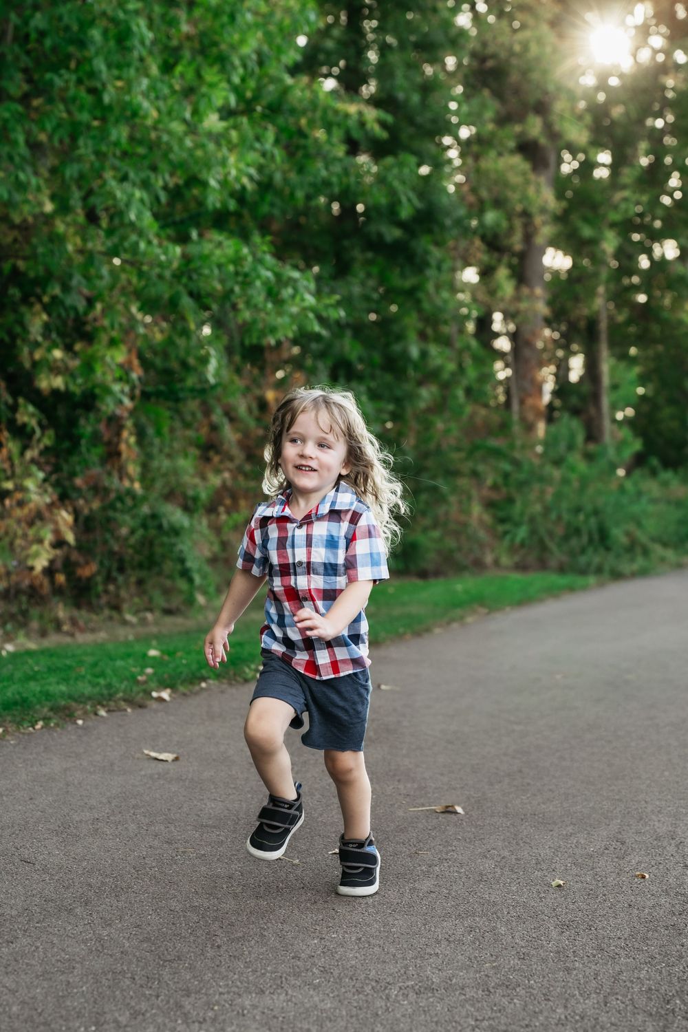 A sequence of photos shows a child in a plaid shirt and shorts playing and jumping on a paved path in Delaware, Ohio Family Photo Session
