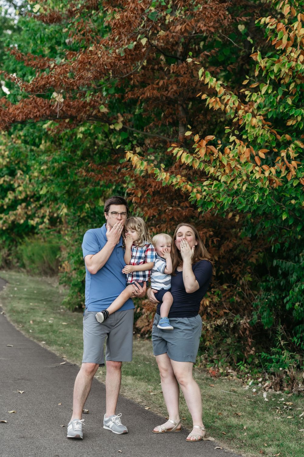 A series of playful candid photos showing people posing and making silly faces in a park with autumn foliage in Delaware, Ohio Family Photos