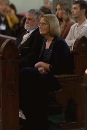 Wedding guests seated in church pews during a traditional ceremony service.
