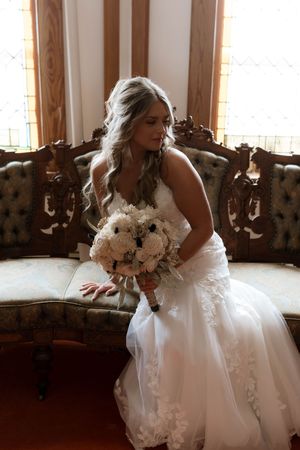 Intricate lace detail and beadwork on the back of a white wedding gown.