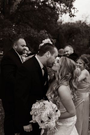 Black and white candid photos of wedding party members sharing joyful moments.