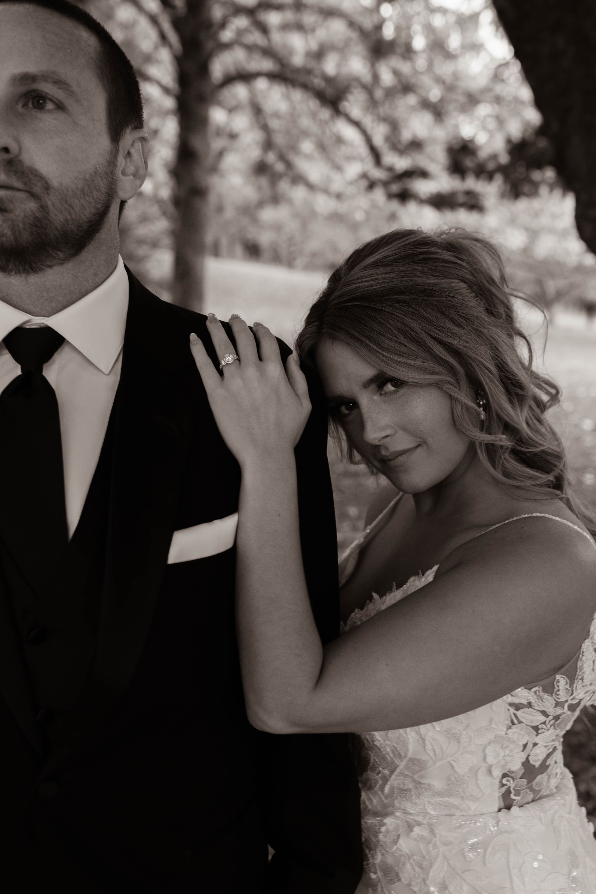 Black and white romantic wedding portrait showing intimate moment between newlyweds.
