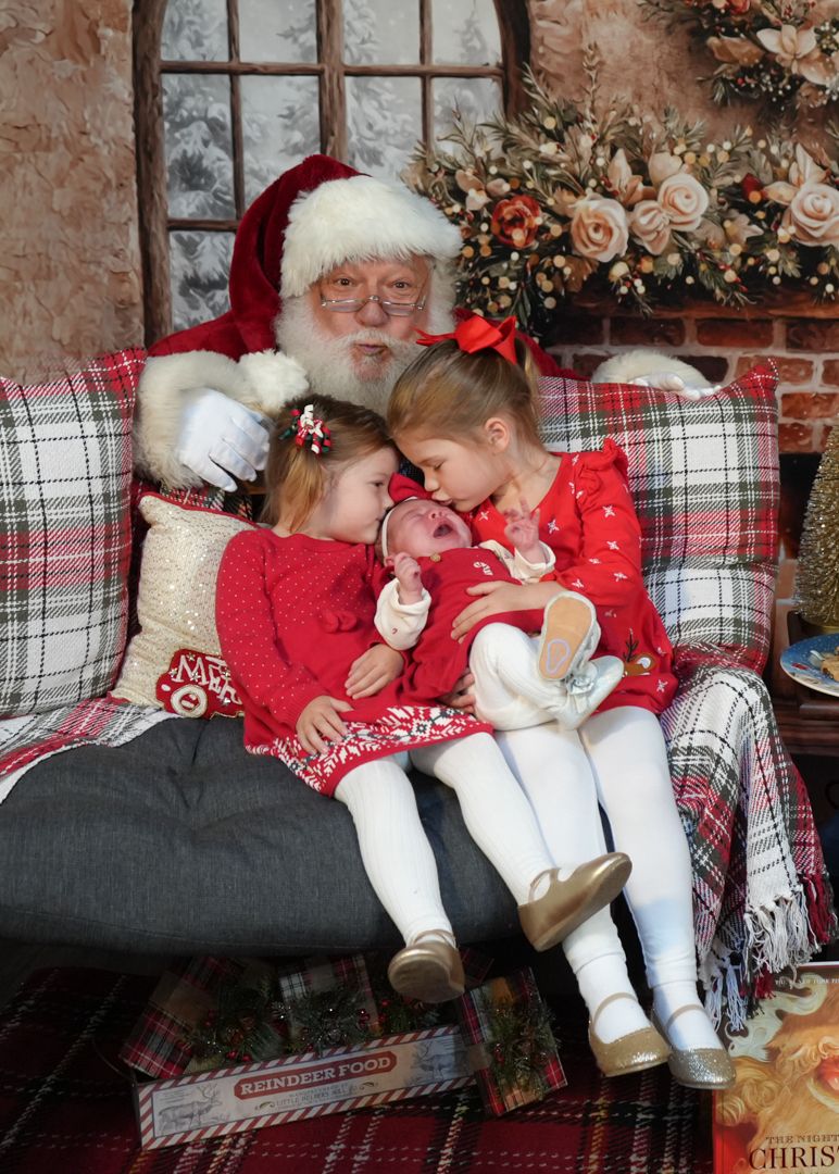 A festive holiday scene with plaid pillows and red decor in a cozy brick-walled setting.