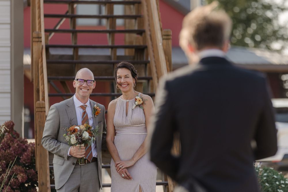 A happy couple shares a joyful moment together during their wedding celebration at an outdoor venue.