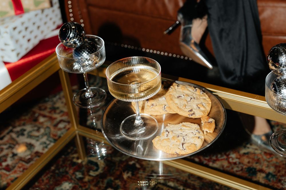 A cozy bar setting with martini glasses and cocktail garnishes arranged on an elegant wooden surface.
