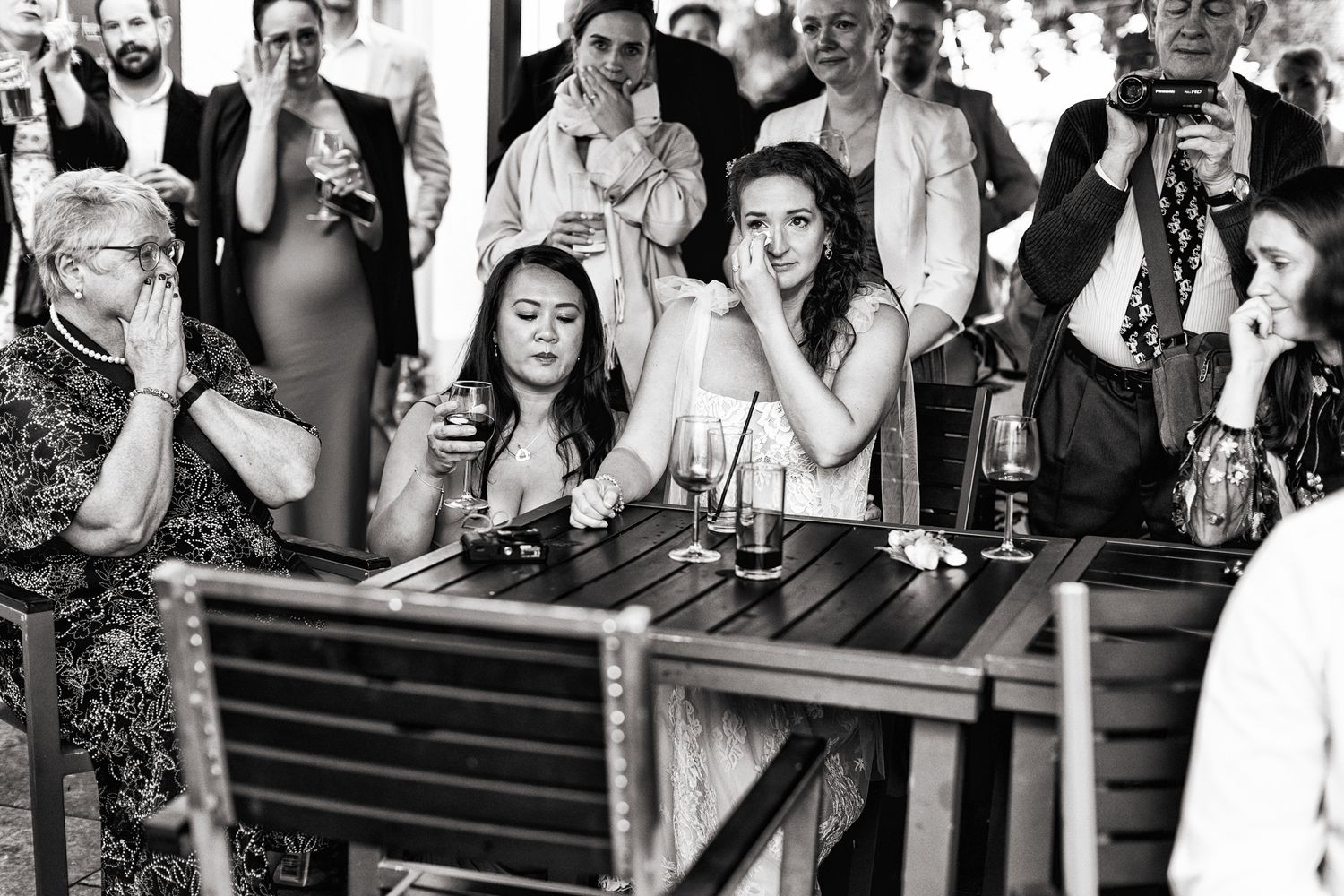 A black and white photo collage shows people celebrating and drinking at what appears to be a bar or party setting.