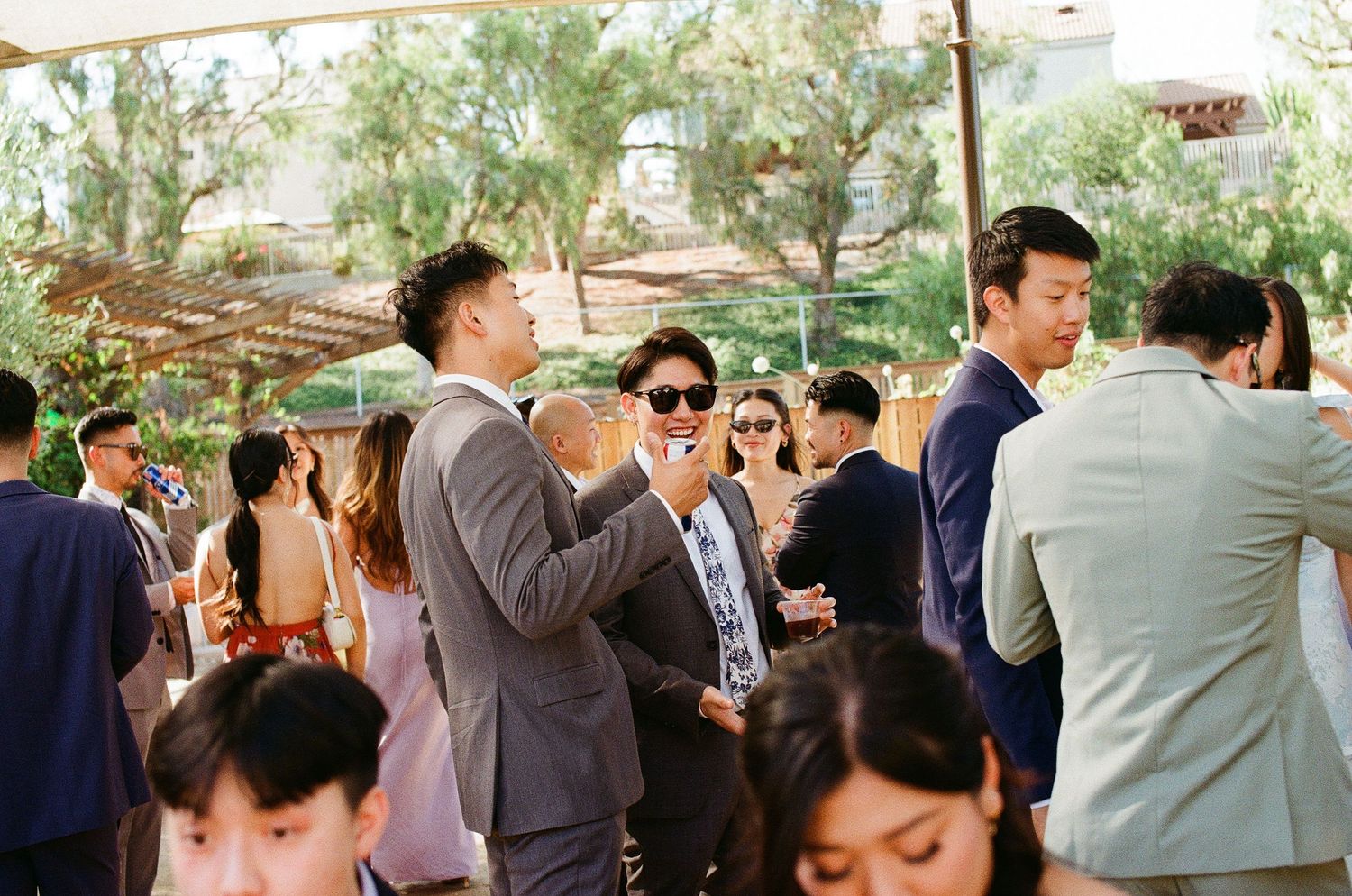 Authentic film photography of guests laughing and having fun at an Orange County secret garden wedding.