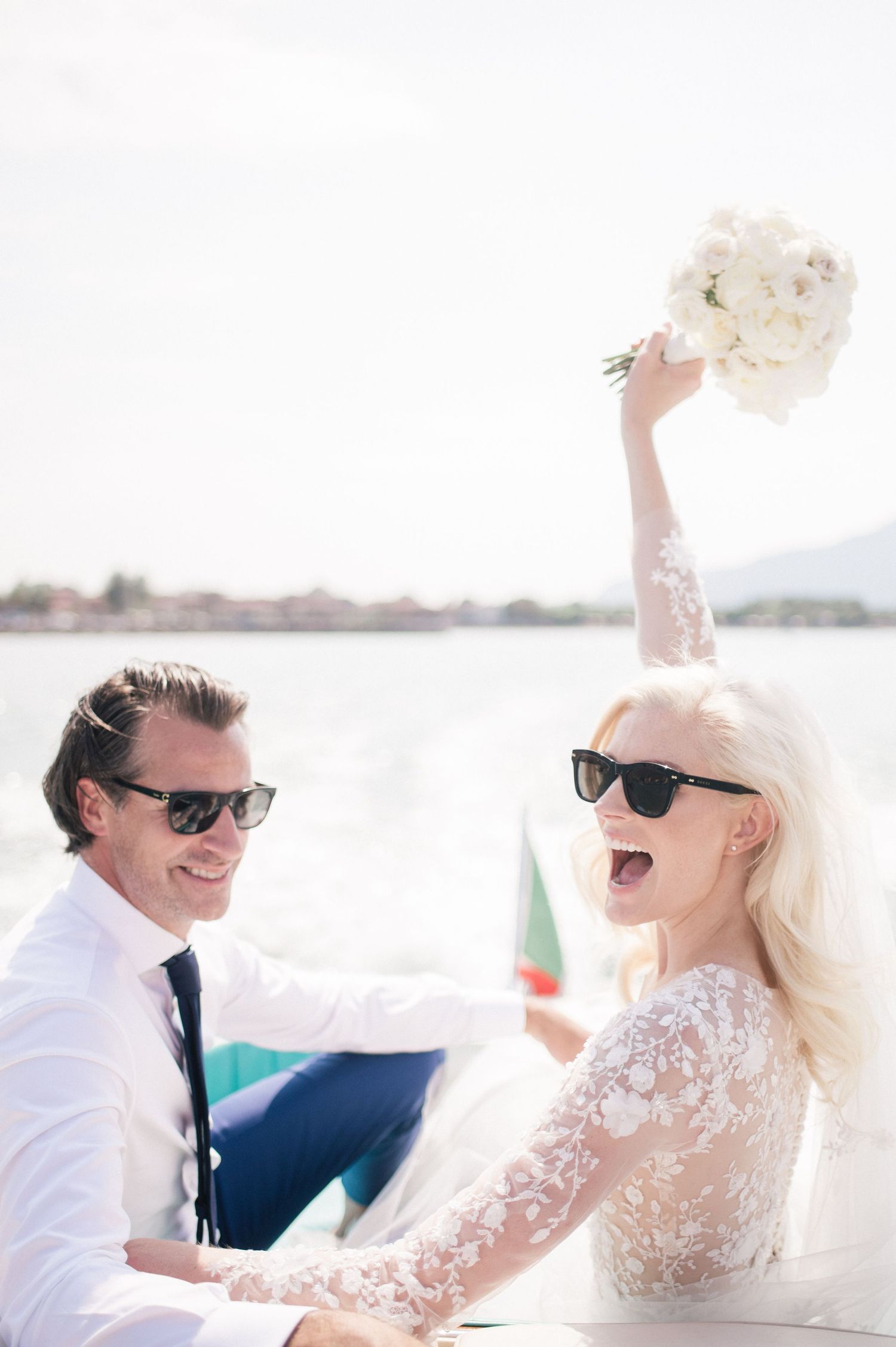 Bride and groom on a Riva boat celebrating their wedding at Lake Iseo, Italy