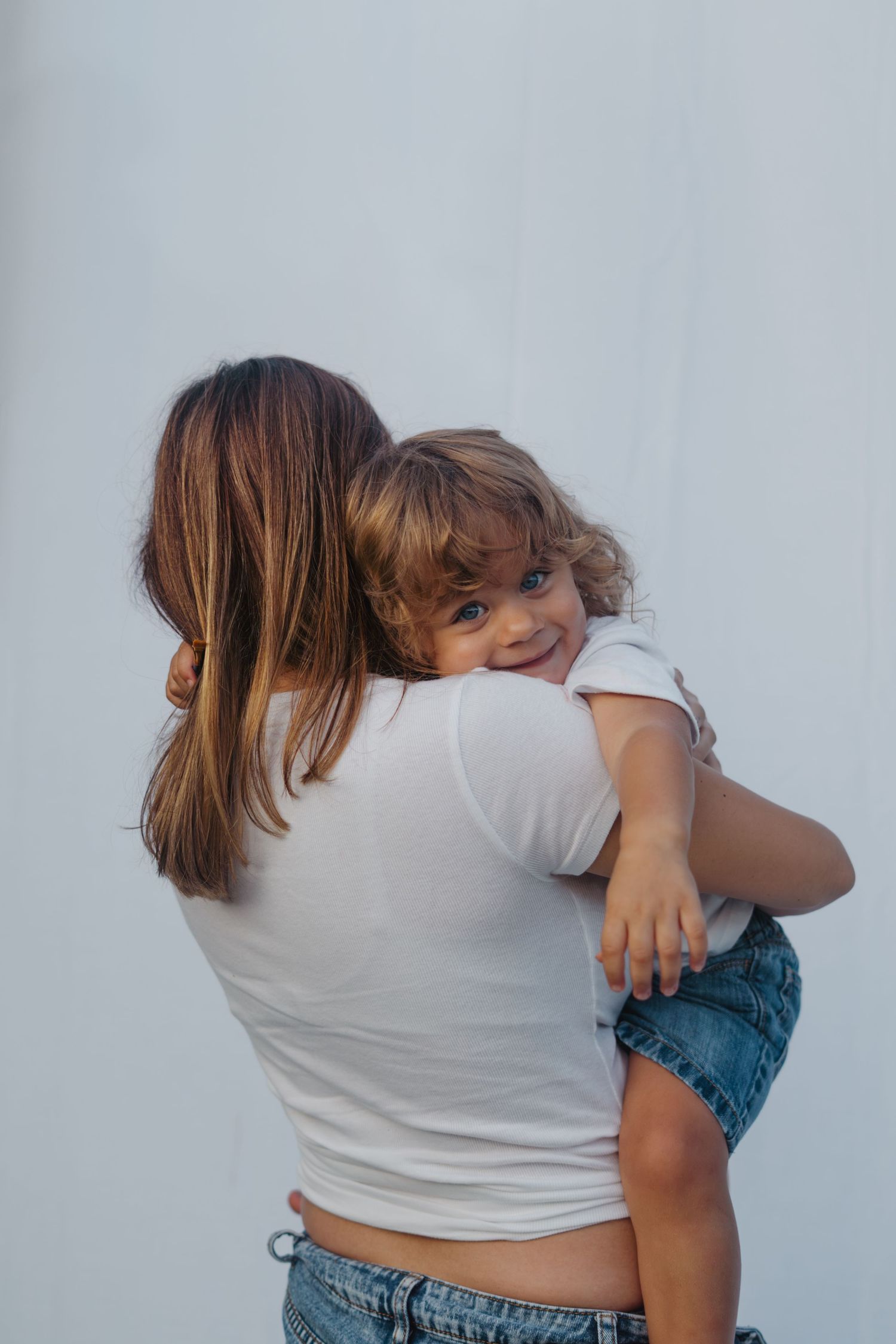 Maternity session outdoors with siblings, playful paint, colorful family photos, natural light, candid moments, lifestyle photography.