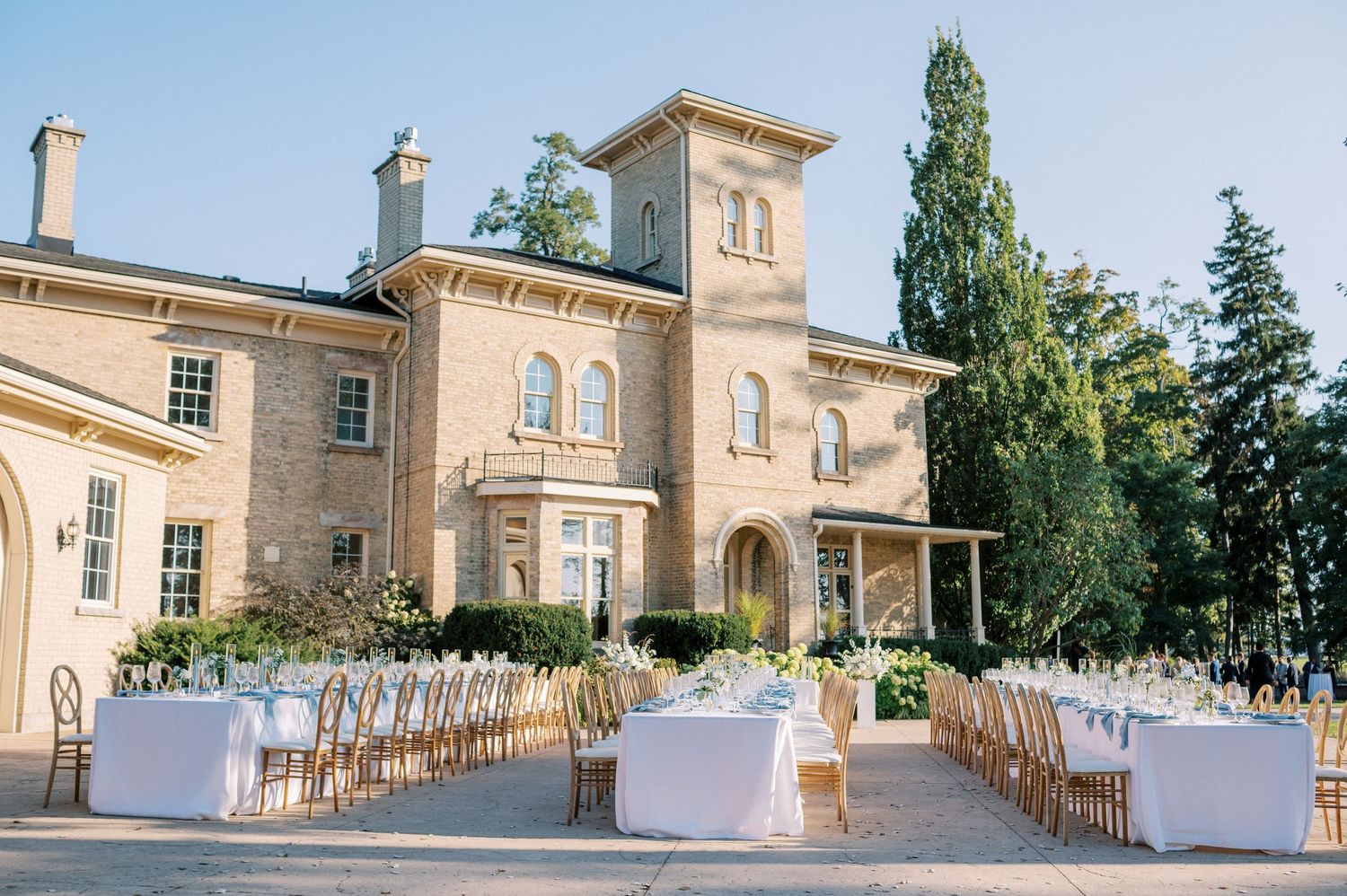 Bride and groom share an emotional first look moment in a garden setting, with the bride wearing a flowing white gown.
