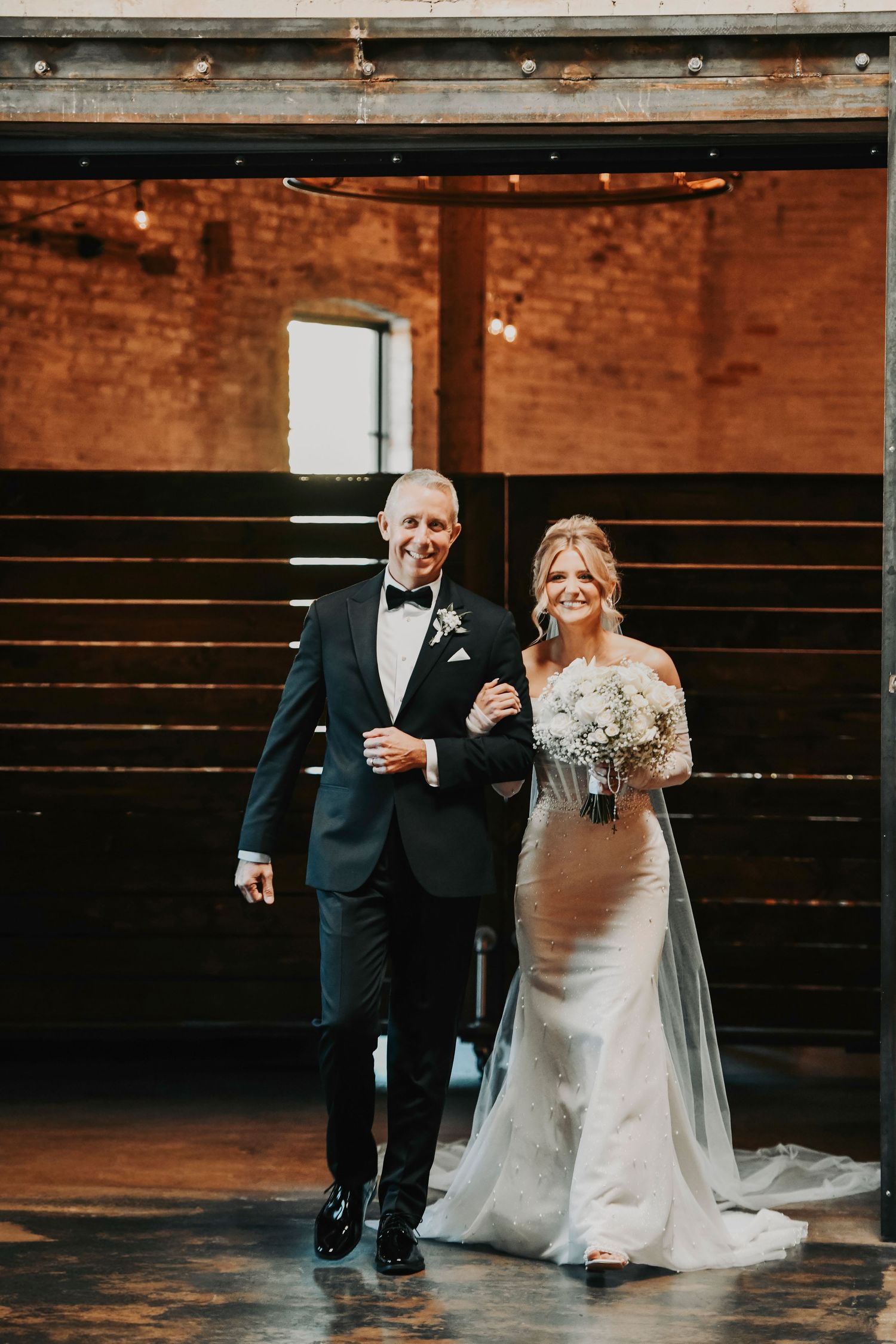 Emotional moment as father walks his daughter into her wedding ceremony at Brake & Clutch Warehouse in Dallas.
