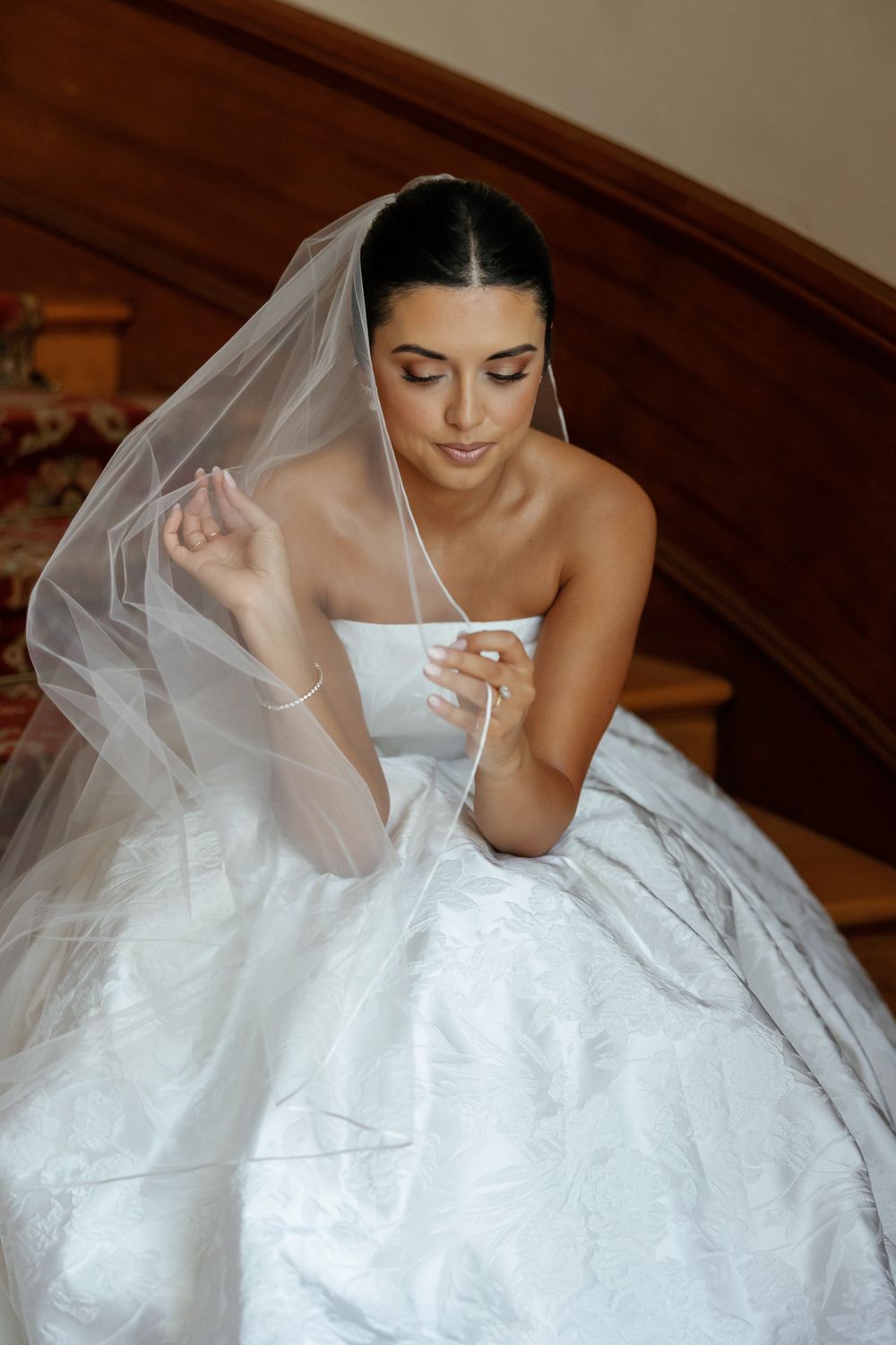 Ethereal bridal portrait showing a flowing white wedding gown and delicate veil.