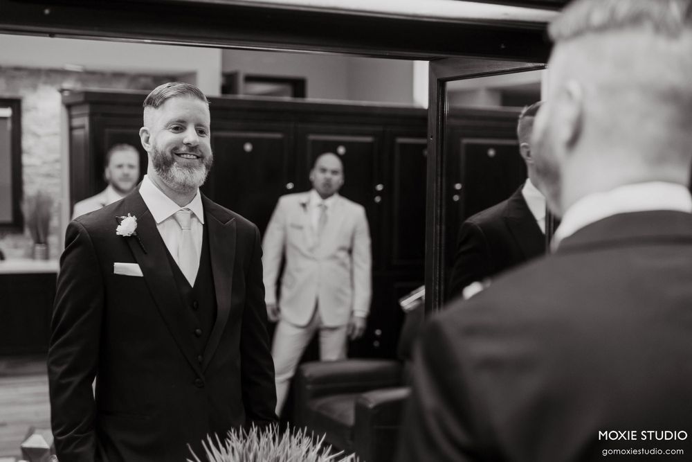 Black and white photo collage showing candid moments at a formal event with people in business attire.