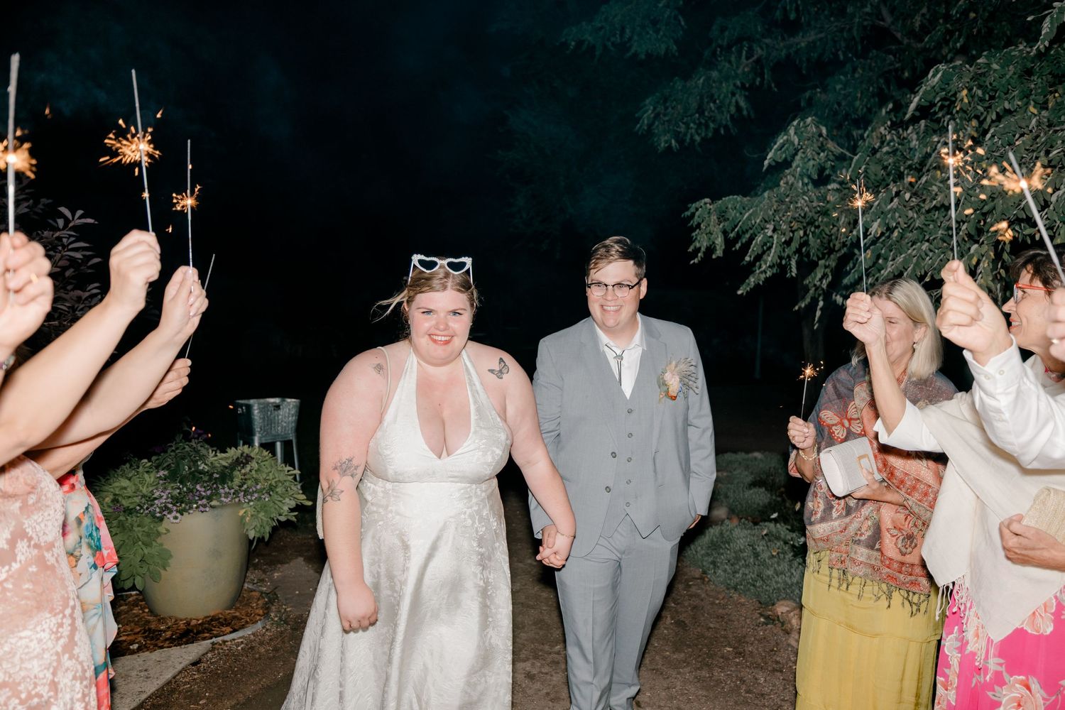 A collection of wedding reception photos showing couples dancing and celebrating under outdoor string lights at night.