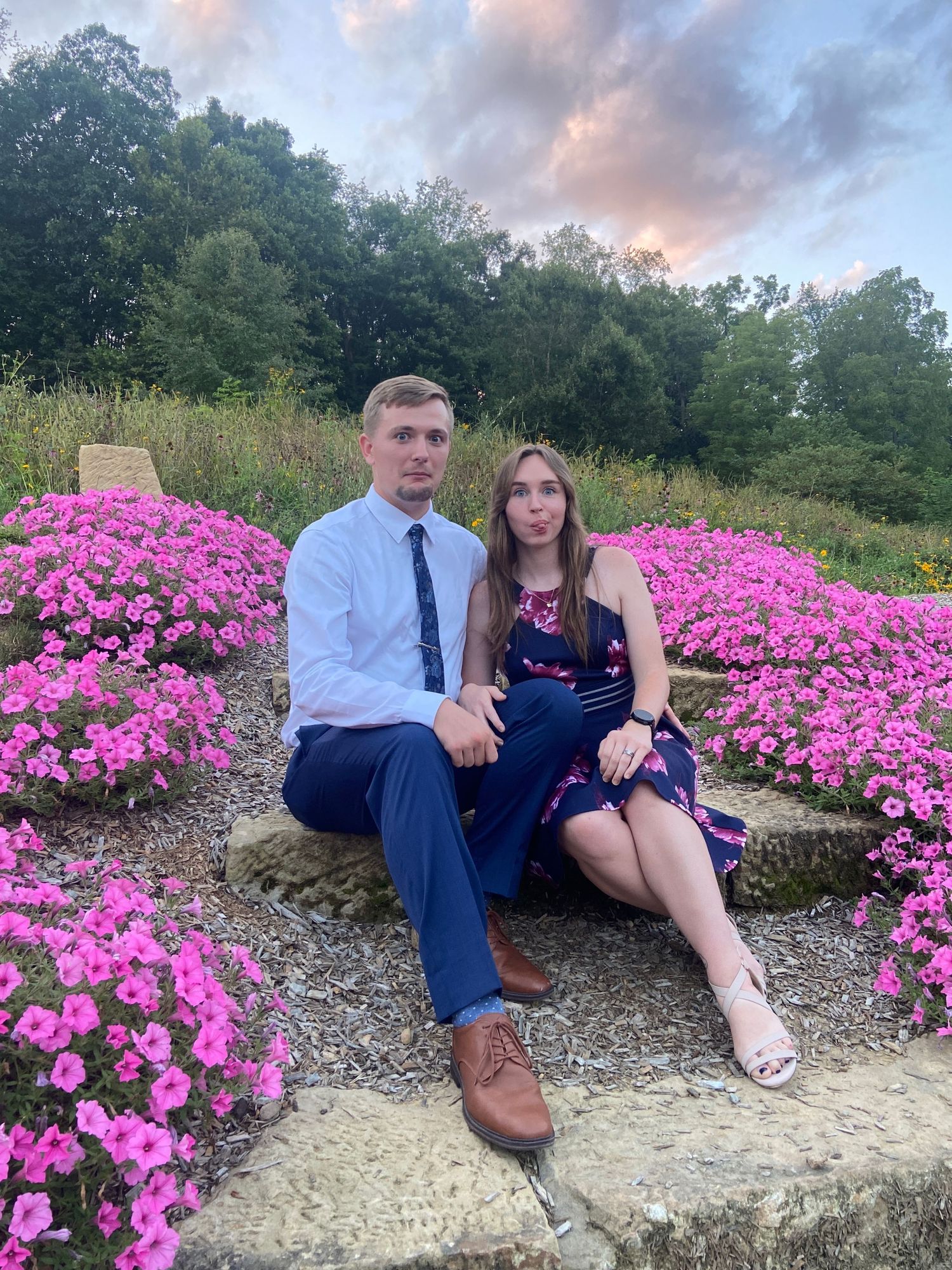 couple sitting on stairs making funny faces