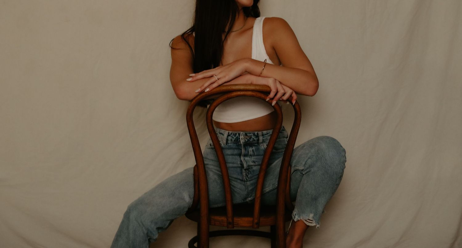 Series of artistic portrait poses in studio against white backdrop.