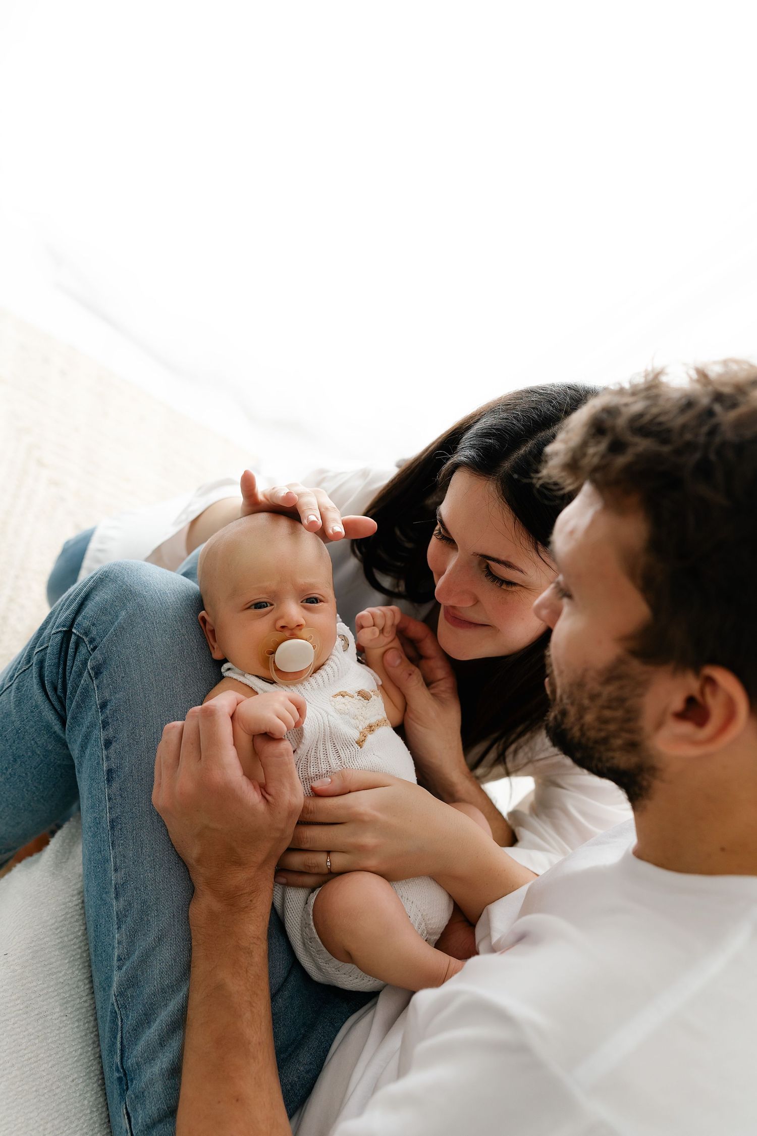 A parent and child share a tender moment on a couch while enjoying playful interactions and bonding.