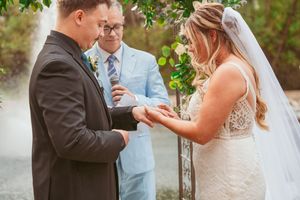 Romantic first dance sequence captured at an outdoor wedding ceremony with a garden backdrop.