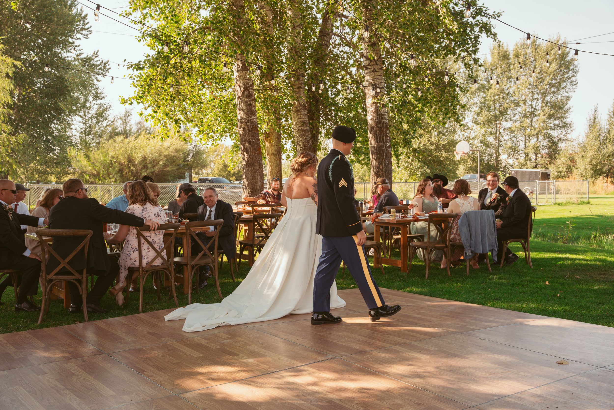 A row of wedding dance photos at an outdoor reception venue features couples dancing under string lights and natural light.