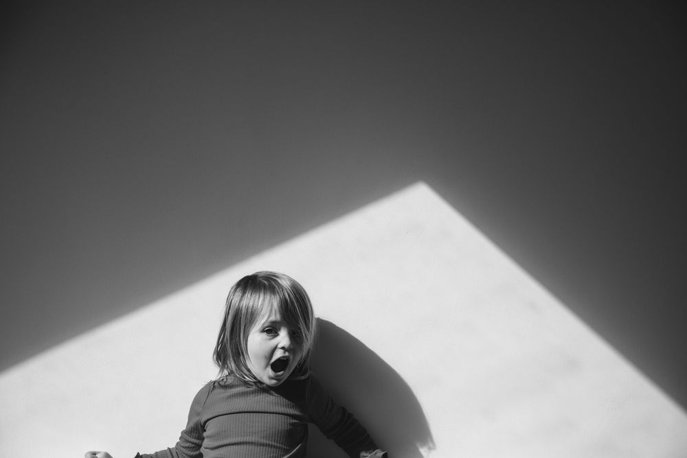 A black and white abstract pattern made with light and shadows against a stark background creates dramatic contrast.