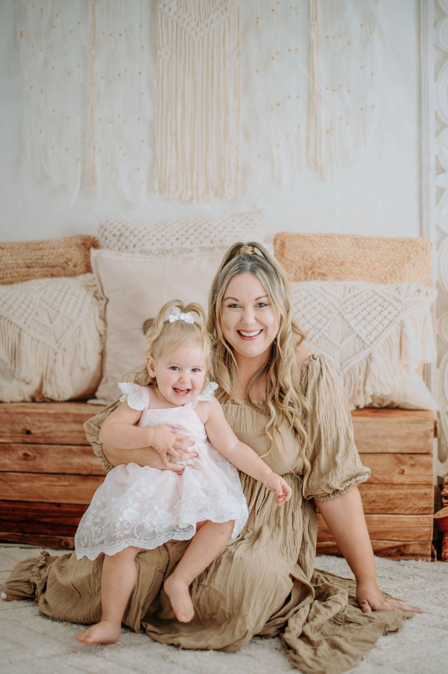 A heartwarming portrait showing two people in neutral tones sitting together against a bohemian-styled backdrop.