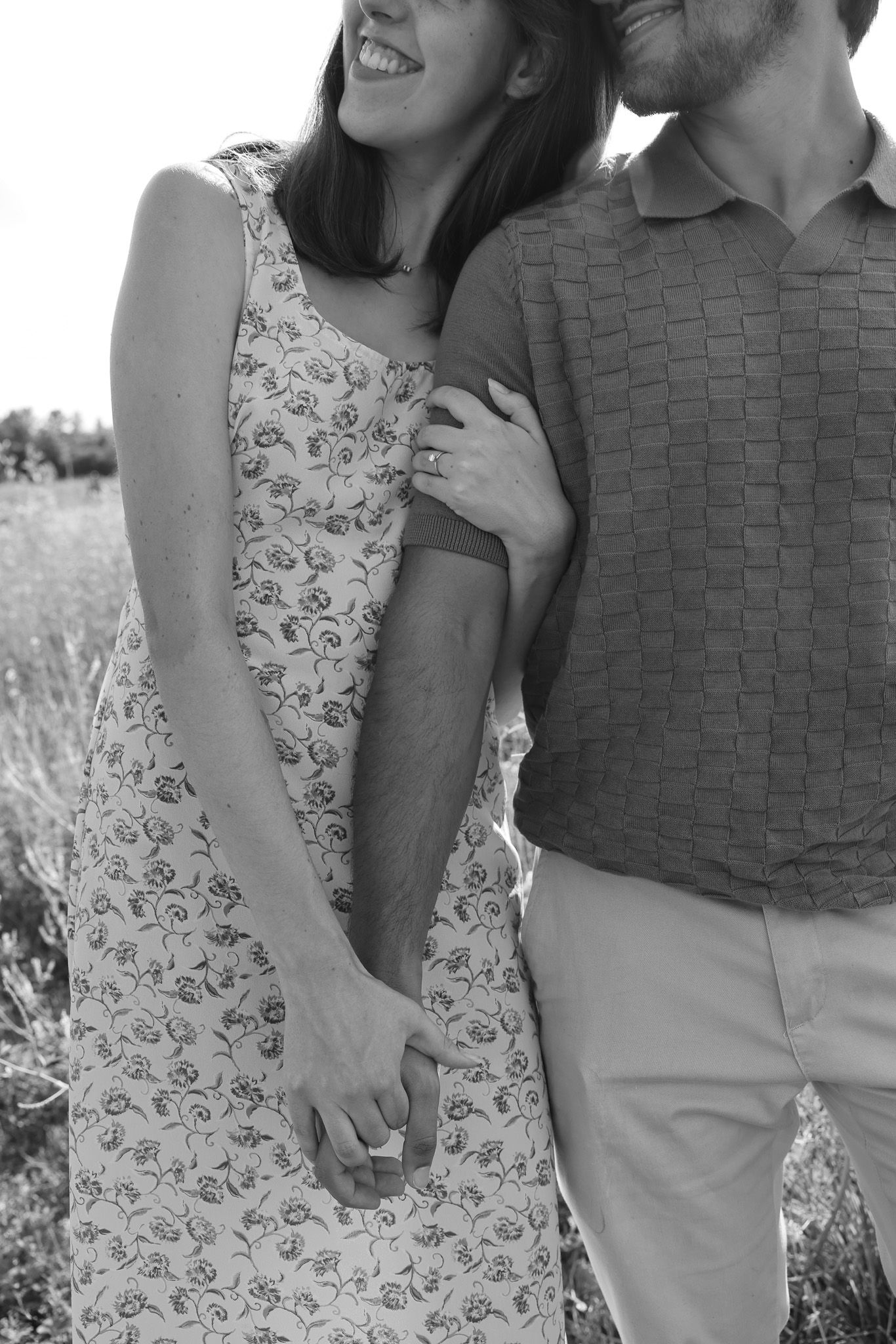 Black and white series of a couple embracing in casual summer outfits.