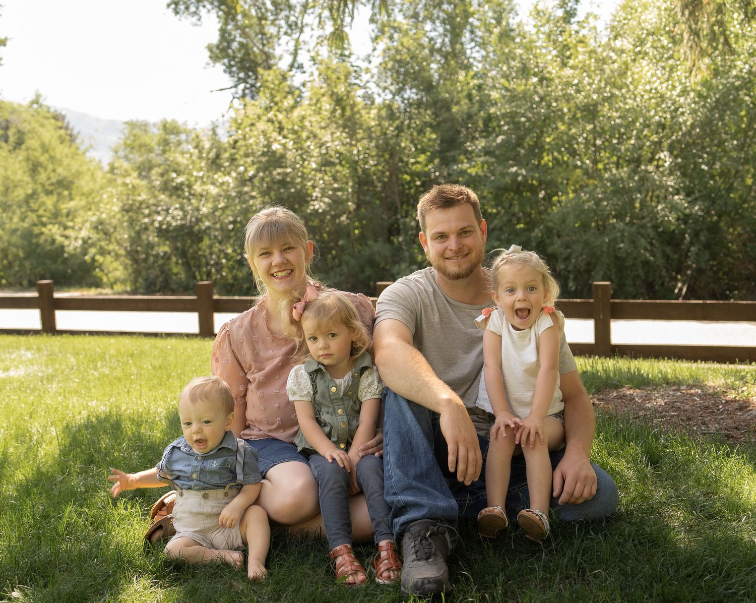 Smiling family enjoying family pictures in Cache Valley. Mack park Smithfield, UT