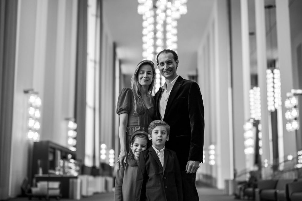 Elegant family photo session at the Kennedy Center in Washington, D.C., featuring stunning indoor chandeliers, panoramic
