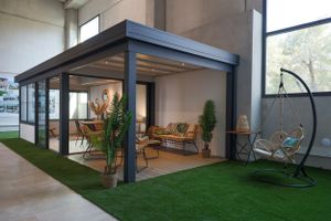 Contemporary covered patio with artificial grass and modern outdoor furniture.