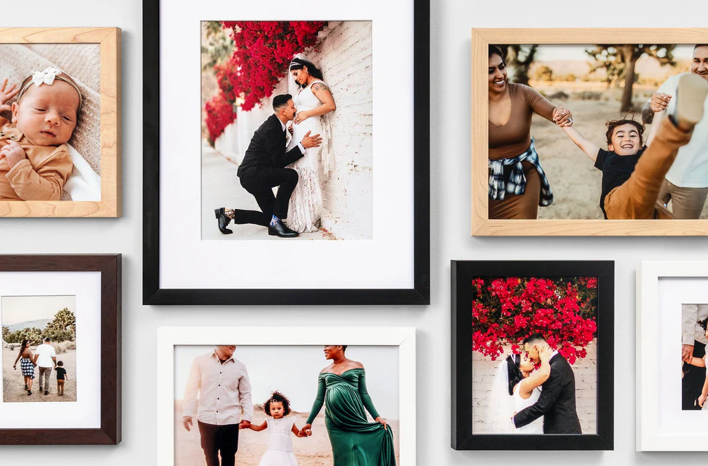 Gallery wall of framed wedding prints from Nations Photo Lab, displayed in a modern home setting as a timeless way to preserve wedding memor