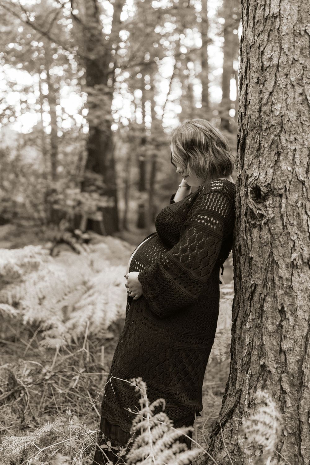 A black and white photo sequence shows someone in a dark sweater playfully hiding behind a tree in the woods.