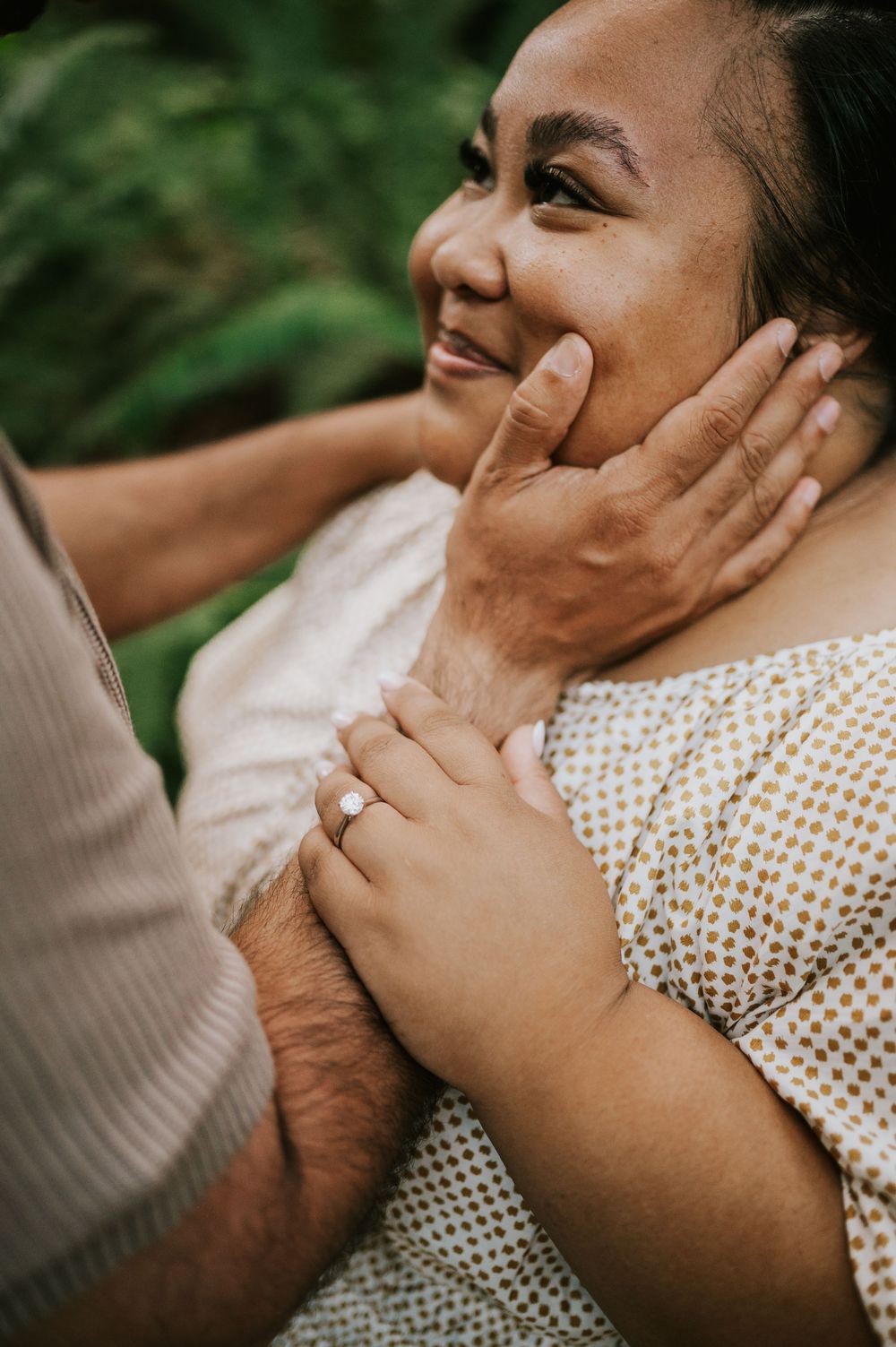 Photo of engaged couple holding each others face in Cathedral Groves, MacMillan Park forest trails. Vancouver Island adventure photographer