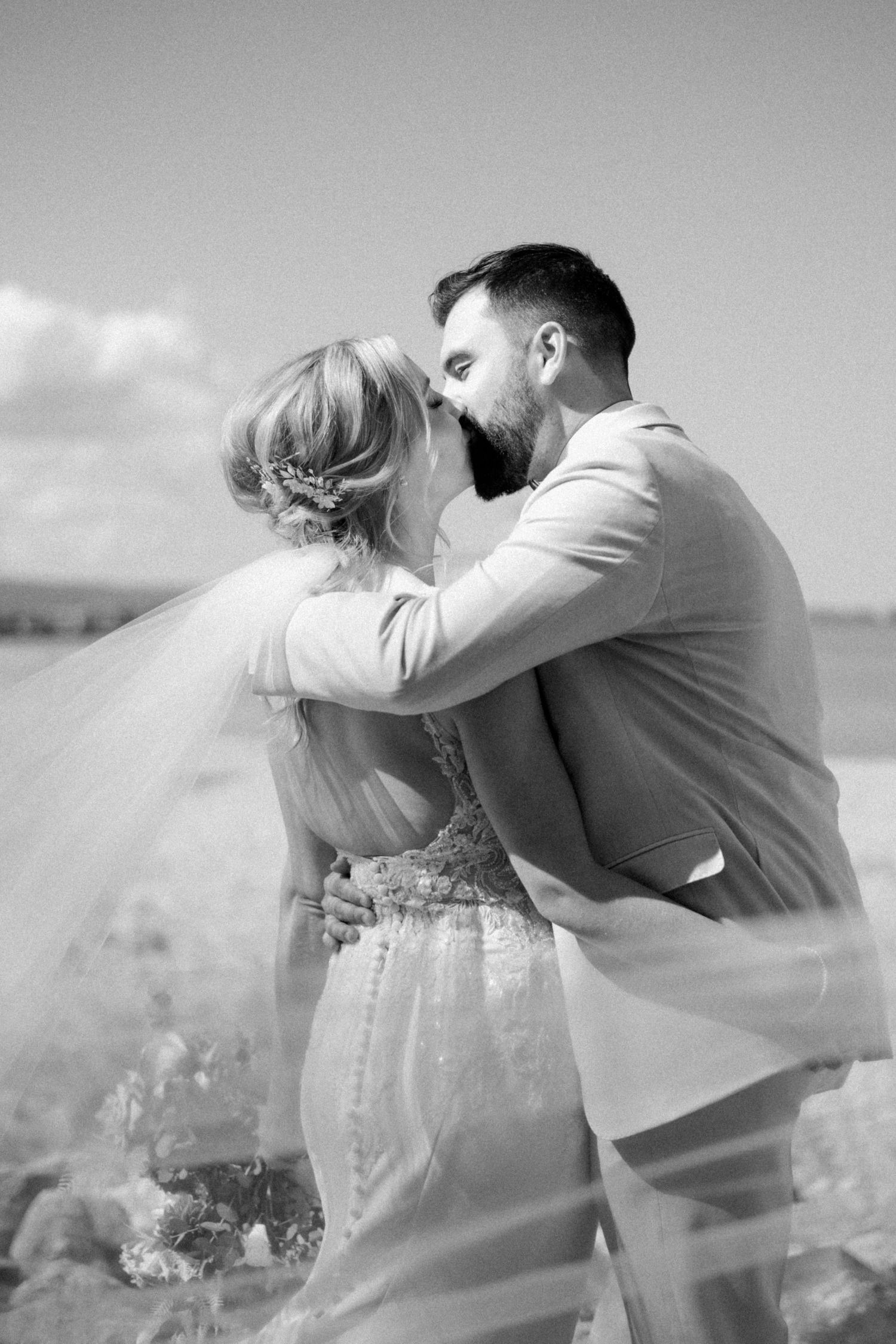 Series of romantic black and white photos showing a couple in formal attire embracing outdoors.