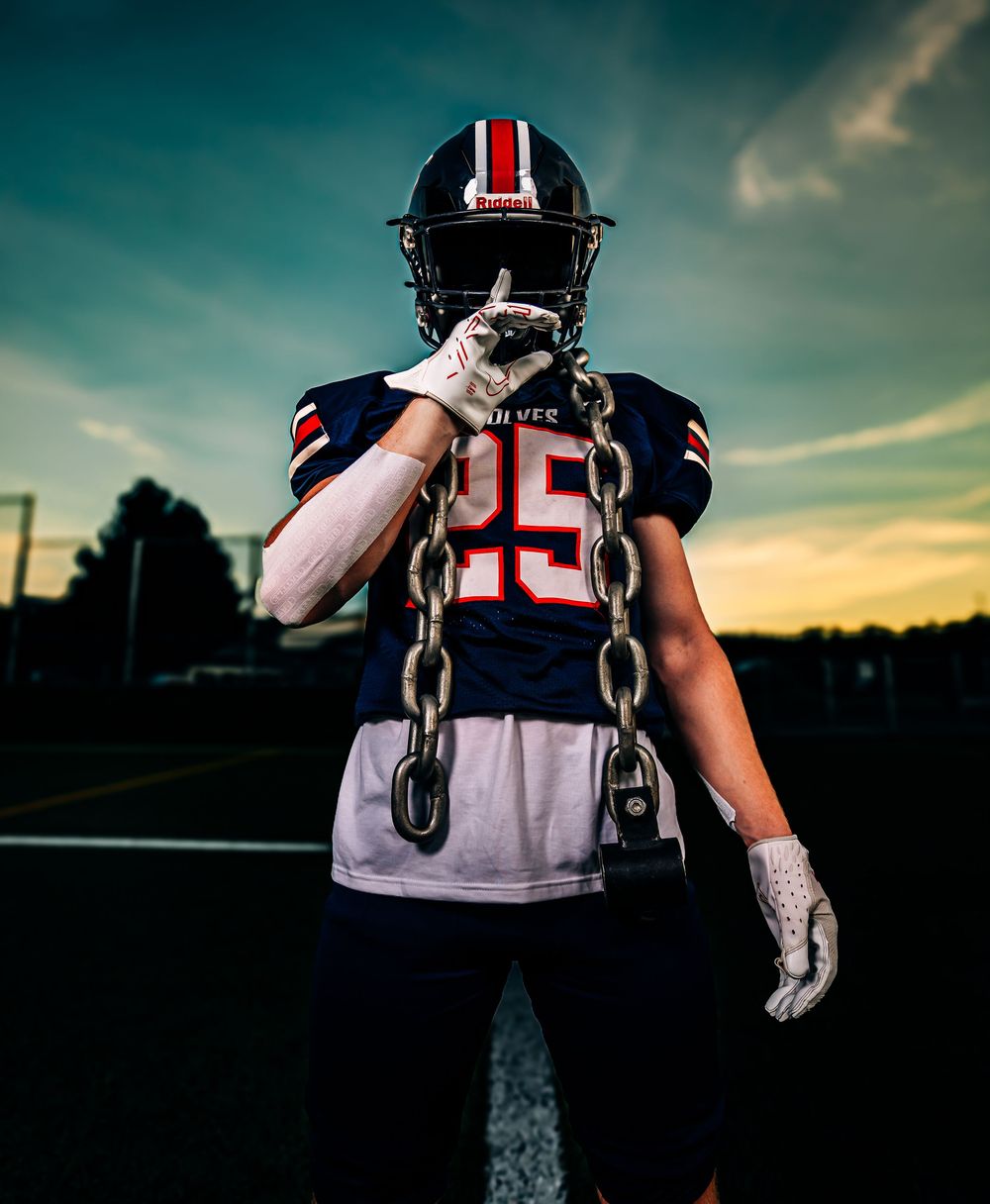 Football player jersey details with player numbers shot at sunset on field.