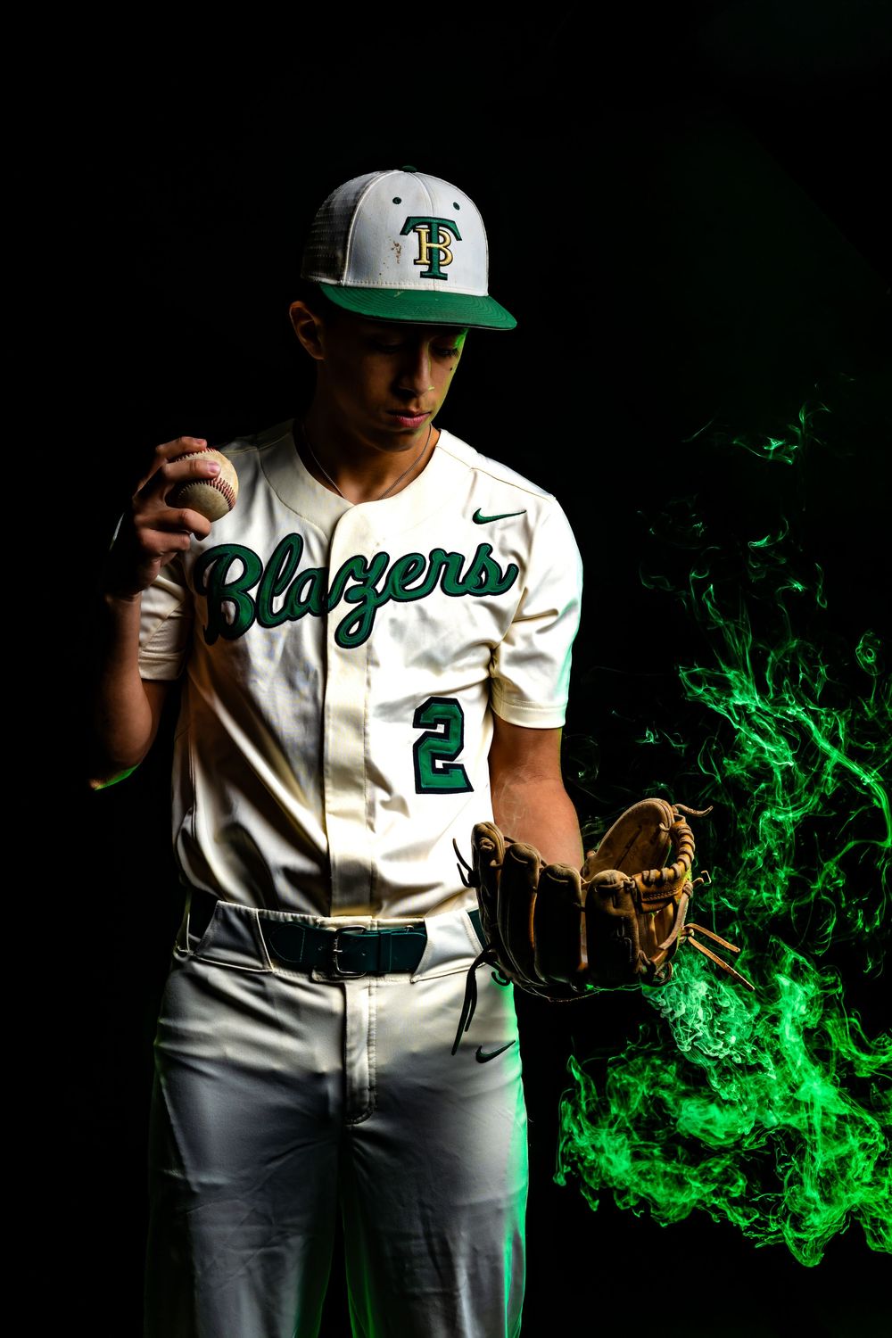 Baseball player in Blazers #2 jersey holds ball with green fire effect on dark background.