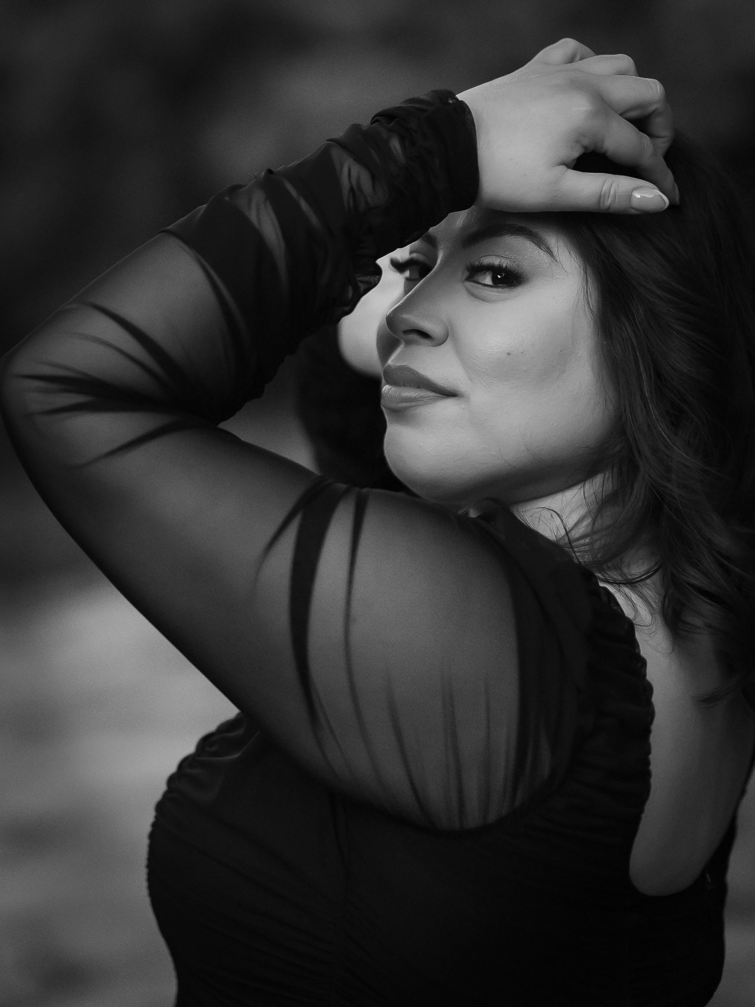 Artistic black and white portrait series showing dramatic lighting and graceful poses against dark background.