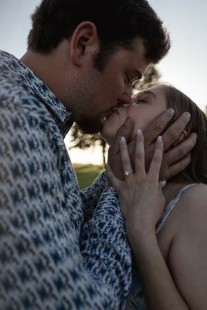 An intimate portrait of a couple sharing a close moment at sunset.