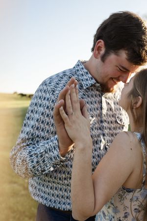 Tender embrace captured in a series of romantic sunset photos in nature.