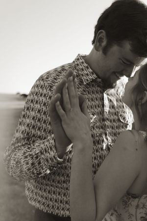 Black and white series showing intimate romantic moments outdoors.