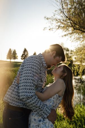 Romantic photoshoot sequence with backlit couple in natural setting.