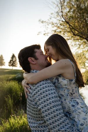 Loving couple sharing an intimate moment in a natural outdoor setting.