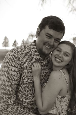 Black and white portrait of couple embracing during engagement session.