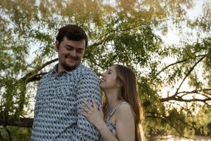 Tender moments between a couple in coordinated outfits during a golden hour photoshoot.